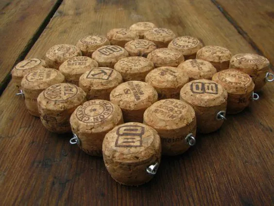 Champagne Cork Tops Trivet - I start by cutting each cork in half. I then drill holes through the sides so I can string them on galvanized wire that is secured with a loop and a grommet and the ends of each row