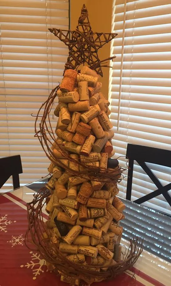This is my version of a wine cork Christmas tree. How I did it: I bought the tallest foam tree "topiary" from Michael's. I hot glued the corks on in 2 layers. 1st layer was very uniform. 2nd layer was more random. Got the grapevine garland at HL & soaked it in hot water for a few hours, then I made a tight "wreath" & zip-tied it together to dry. I wired it to the corks. Star came from the "mini" tree section @ HL. I straightened the wire base to stick into the foam tree. Merry Christmas! S